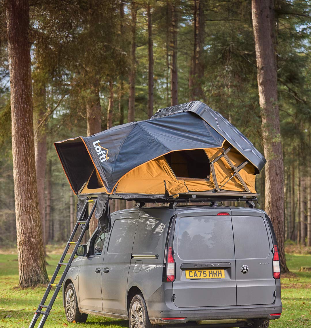 Lofti Betty 30 second hard-shell rooftop tent on a grey VW Caddy in a forest
