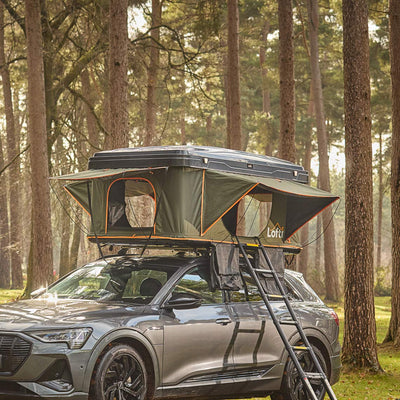 Lofti Maggie aerodynamic hard-shell rooftop tent on a grey Audi SUV in a forest